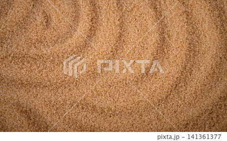 Brown cane sugar pile textured background top view Brown cane sugar pile textured background top view 141361377
