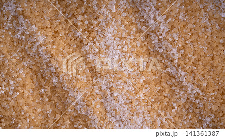 Brown cane sugar pile textured background top view Brown cane sugar pile textured background top view 141361387