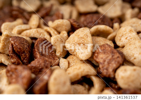 Chocolate cereal flakes textured background closeup Chocolate cereal flakes textured background closeup 141361537
