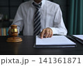 Lawyer Reviewing Contract and Documents with Gavel on Desk. 141361871