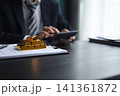 Gold investment Concept. Businessman working on financial planning and gold investment analysis with bullion and calculator. 141361872