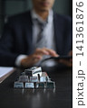 Stacked Silver Bars on the table with businessman managing his precious metals portfolio in office desk. 141361876