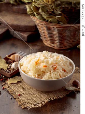 Homemade sauerkraut with carrot on an old wooden table. 141364569