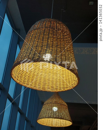 Decorative bamboo lamps, hanging yellow wicker lamp, warm light wooden lamp. Handmade lamps close up. Decorative bamboo lamps, hanging yellow wicker lamp, warm light wooden lamp. Handmade lamps close up. 141365032