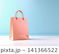 Minimalistic and stylish consumers. Paper shopping bag on a white background. Bag mockup in orange color for promoting brands. 141366522