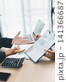 Business professionals discussing financial report on clipboard with charts, calculator and laptop in office, showing accounting consultation, planning and data analysis. 141366687