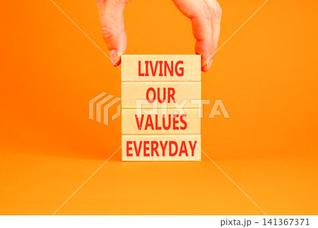 Living our values everyday words symbol. Concept words Living our values everyday on beautiful wooden blocks. Beautiful orange background. Business living our values everyday concept. Copy space. Living our values everyday words symbol. Concept words Living our values everyday on beautiful wooden blocks. Beautiful orange background. Business living our values everyday concept. Copy space. 141367371