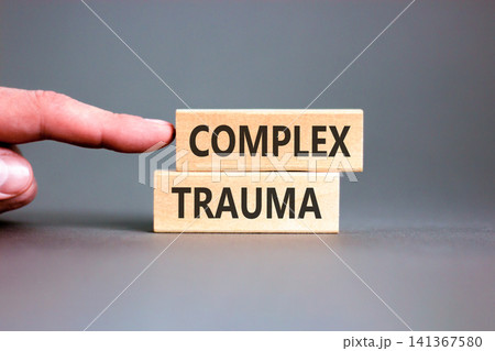 Complex trauma words symbol. Concept words Complex trauma on beautiful wooden blocks. Beautiful grey background. Psychologist hand. Psychological complex trauma support concept. Copy space. Complex trauma words symbol. Concept words Complex trauma on beautiful wooden blocks. Beautiful grey background. Psychologist hand. Psychological complex trauma support concept. Copy space. 141367580