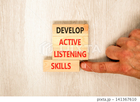 Develop active listening skills symbol. Concept words Develop active listening skills on beautiful wooden blocks. Beautiful grey wooden background. Business active listening skills concept. Copy space Develop active listening skills symbol. Concept words Develop active listening skills on beautiful wooden blocks. Beautiful grey wooden background. Business active listening skills concept. Copy space 141367610