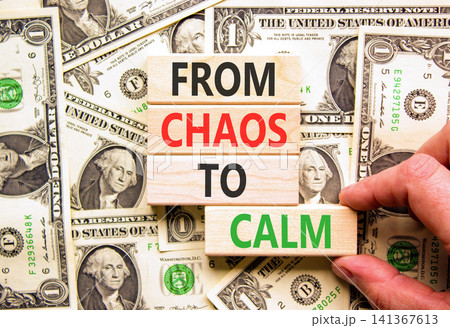 From chaos to calm symbol. Concept words From chaos to calm on beautiful wooden blocks. Beautiful dollar bills background. Dollar bills. Business psychological from chaos to calm concept. Copy space. From chaos to calm symbol. Concept words From chaos to calm on beautiful wooden blocks. Beautiful dollar bills background. Dollar bills. Business psychological from chaos to calm concept. Copy space. 141367613