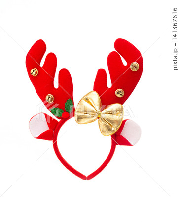 Festive red felt reindeer antler headband with bells, holly, and a gold bow on white. Festive red felt reindeer antler headband with bells, holly, and a gold bow on white. 141367616