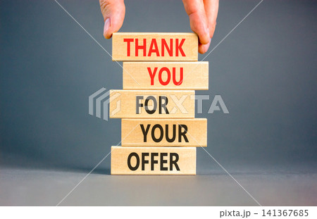 Thank you for your offer symbol. Concept words Thank you for your offer on beautiful wooden blocks. Beautiful grey background. Businessman hand. Business thank you for your offer concept. Copy space 141367685