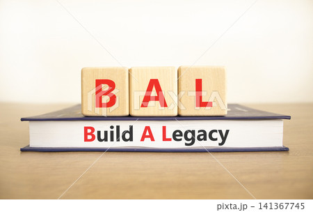 BAL build a legacy symbol. Concept words BAL build a legacy on beautiful wooden blocks and book. Beautiful white background. Business BAL build a legacy concept. Copy space 141367745