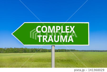 Complex trauma words symbol. Concept words Complex trauma on beautiful green road sign. Beautiful blue sky green field background. Psychological complex trauma support concept. Copy space. 141368029