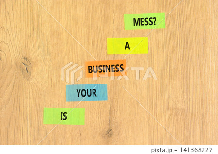 Is your business a mess symbol. Concept words Is your business a mess on beautiful colored papers. Beautiful wooden background. Is your business a mess concept. Copy space. Is your business a mess symbol. Concept words Is your business a mess on beautiful colored papers. Beautiful wooden background. Is your business a mess concept. Copy space. 141368227