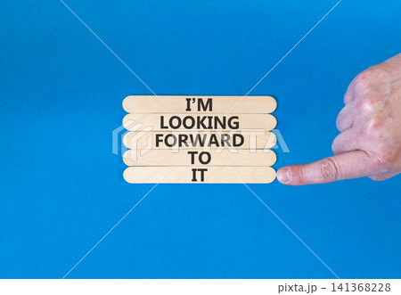 I'm looking forward to it symbol. Concept words I'm looking forward to it on beautiful wooden sticks. Beautiful blue background. Business and I'm looking forward to it concept. Copy space. I'm looking forward to it symbol. Concept words I'm looking forward to it on beautiful wooden sticks. Beautiful blue background. Business and I'm looking forward to it concept. Copy space. 141368228