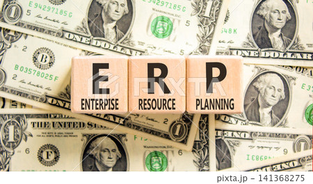 ERP enterprise resource planning symbol. Concept words ERP enterprise resource planning on beautiful wooden blocks. Beautiful dollar bills background. Business ERP concept. Copy space. 141368275