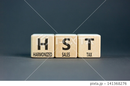 HST harmonized sales tax symbol. Concept words HST harmonized sales tax on beautiful wooden blocks. Beautiful grey background. Business HST harmonized sales tax concept. Copy space 141368276