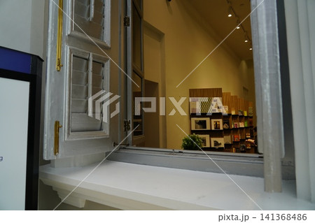 Historic Window View into a Charming Shop Interior 141368486