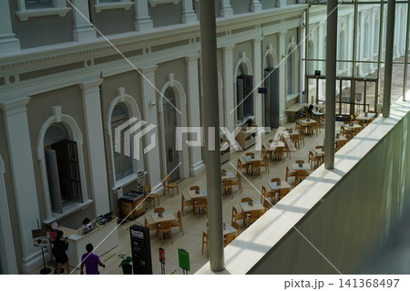 Spacious cafe interior with elegant architecture and open seating Spacious cafe interior with elegant architecture and open seating 141368497