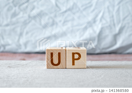 motivational word Up made of letters on wooden cubes motivational word Up made of letters on wooden cubes 141368580