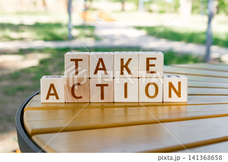 motivational phrase Take Action made of letters on wooden cubes motivational phrase Take Action made of letters on wooden cubes 141368658