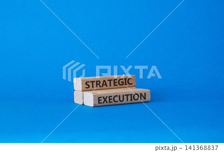 Strategic execution symbol. Concept word Strategic execution on wooden blocks. Beautiful blue background. Business and Strategic execution concept. Copy space 141368837
