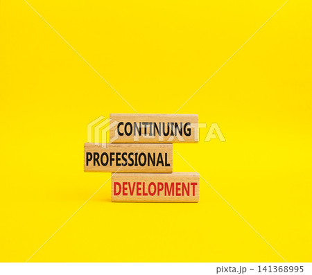 Continuing Development symbol. Concept words Continuing Professional Development on wooden blocks. Beautiful yellow background. Business and Development concept. Copy space 141368995