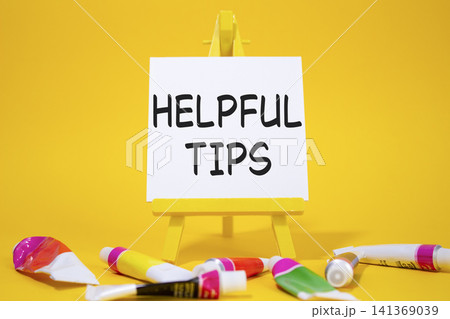 Helpful tips symbol. Wooden blocks with words Helpful tips. Beautiful yellow background with paints and easel. Business and Helpful tips concept. Copy space. Helpful tips symbol. Wooden blocks with words Helpful tips. Beautiful yellow background with paints and easel. Business and Helpful tips concept. Copy space. 141369039