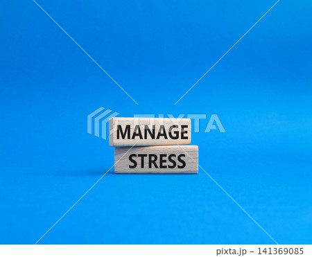 Manage stress symbol. Concept word Manage stress on wooden blocks. Beautiful blue background. Business and Manage stress concept. Copy space Manage stress symbol. Concept word Manage stress on wooden blocks. Beautiful blue background. Business and Manage stress concept. Copy space 141369085