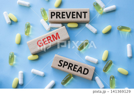 Prevent Germ Spread symbol. Concept words Prevent Germ Spread on wooden blocks. Beautiful blue background with pills. Healthcare and Prevent Germ Spread concept. Copy space. Prevent Germ Spread symbol. Concept words Prevent Germ Spread on wooden blocks. Beautiful blue background with pills. Healthcare and Prevent Germ Spread concept. Copy space. 141369129