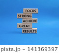 Great Results symbol. Wooden blocks with words Focus strong achieve great results. Beautiful blue background. Business and Great Results concept. Copy space 141369397