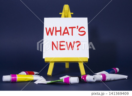 What is new symbol. Concept word What is new on wooden blocks. Beautiful deep blue background with paints and easel. Business and What is new concept. Copy space What is new symbol. Concept word What is new on wooden blocks. Beautiful deep blue background with paints and easel. Business and What is new concept. Copy space 141369409