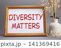 Diversity matters symbol. Concept words Diversity matters on beautiful wooden picture frame. Beautiful grey background with flower vase. Business and Diversity matters concept. Copy space. 141369416