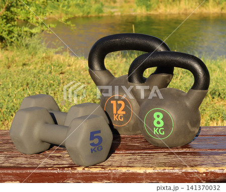 dumbbells on wooden path dumbbells on wooden path 141370032