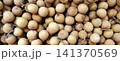 A full-frame photo showing the texture of a dense pile of fresh longan fruit. 141370569