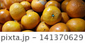 A pile of fresh, ripe mandarin oranges. 141370629