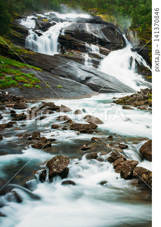Rushing river rapids over rocks in Husedalen Valley. Rushing river rapids over rocks in Husedalen Valley. 141370846