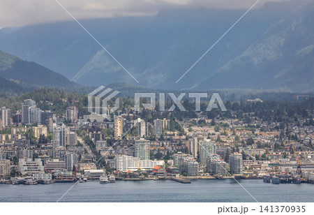 Cityscape view of North Vancouver from downtown Vancouver British Columbia Canada with bay of water and boats. Modern housing development. Travel photo, editorial. July 10,2022 141370935