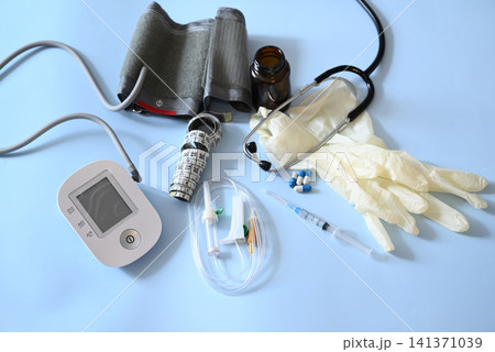 Medical supplies and equipment on a blue surface with a focus on tools for health monitoring and examination 141371039