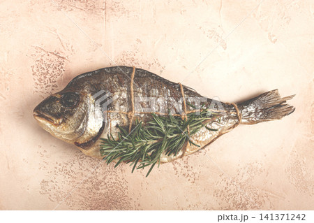 hot smoked dorado fish, with a sprig of rosemary, tied with a rope, on the table, top view, smoked fish, close-up, no people, hot smoked dorado fish, with a sprig of rosemary, tied with a rope, on the table, top view, smoked fish, close-up, no people, 141371242