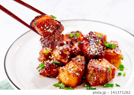 Chinese-style meat with sesame seeds and green onions, on a white plate, marble table, homemade, no people, 141371262