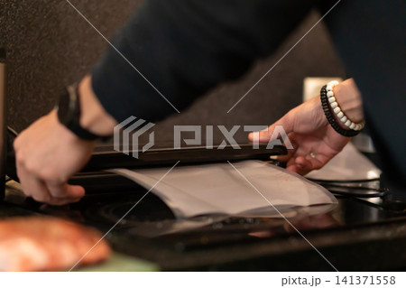 Hands Placing Marinated Pork Into Vacuum Seal Plastic Bag Hands Placing Marinated Pork Into Vacuum Seal Plastic Bag 141371558