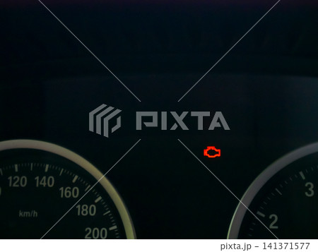 Check engine light glowing red on car dashboard instrument panel. Vehicle malfunction warning indicator during drive. Automotive maintenance problem and technical service diagnostic alert. Check engine light glowing red on car dashboard instrument panel. Vehicle malfunction warning indicator during drive. Automotive maintenance problem and technical service diagnostic alert. 141371577