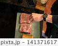 Overhead View Seasoned Raw Pork Pieces on Cutting Board 141371617