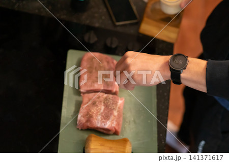 Overhead View Seasoned Raw Pork Pieces on Cutting Board Overhead View Seasoned Raw Pork Pieces on Cutting Board 141371617