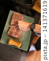 Overhead View Seasoned Raw Pork Pieces on Cutting Board 141371619