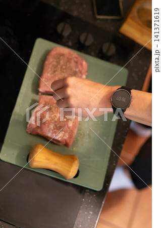 Overhead View Seasoned Raw Pork Pieces on Cutting Board Overhead View Seasoned Raw Pork Pieces on Cutting Board 141371619