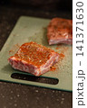 Close Up Raw Pork Rib Piece Covered in Red Paprika Rub 141371630