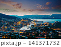 Wide sunset panorama of Bergen with pink clouds and city lights. Wide sunset panorama of Bergen with pink clouds and city lights. 141371732